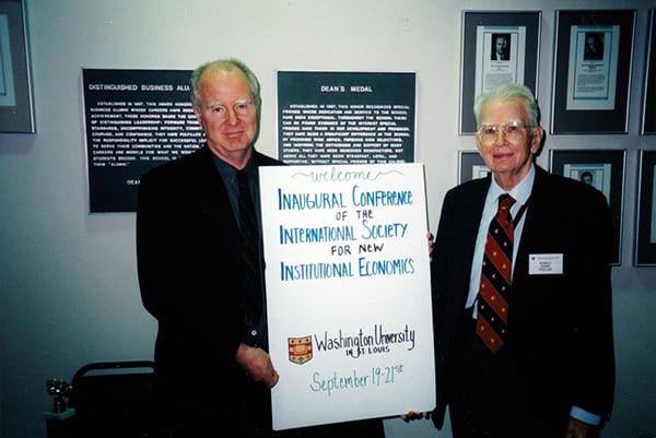 Ronald Coase (right) with conference organizer Lee Benham during the inaugural ISNIE conference 1997 in St. Louis.